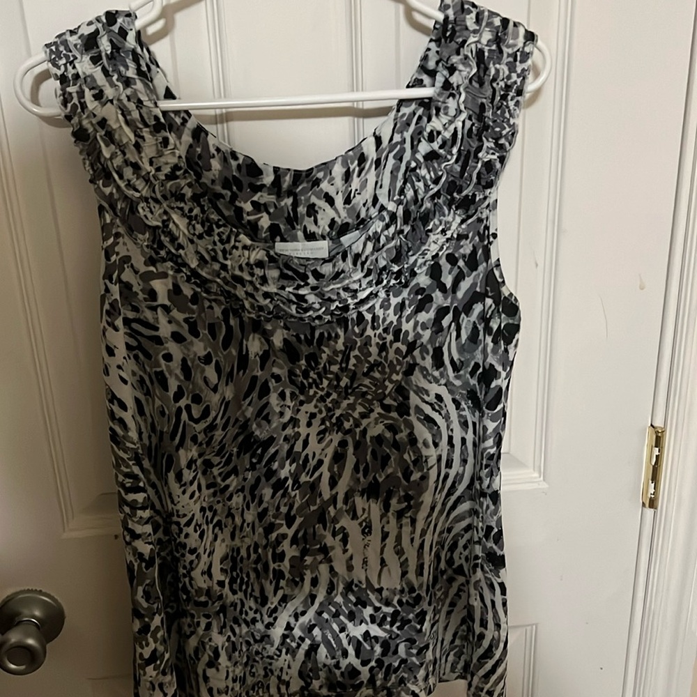 Black, cream and gray tank top, has ruffles around neck area